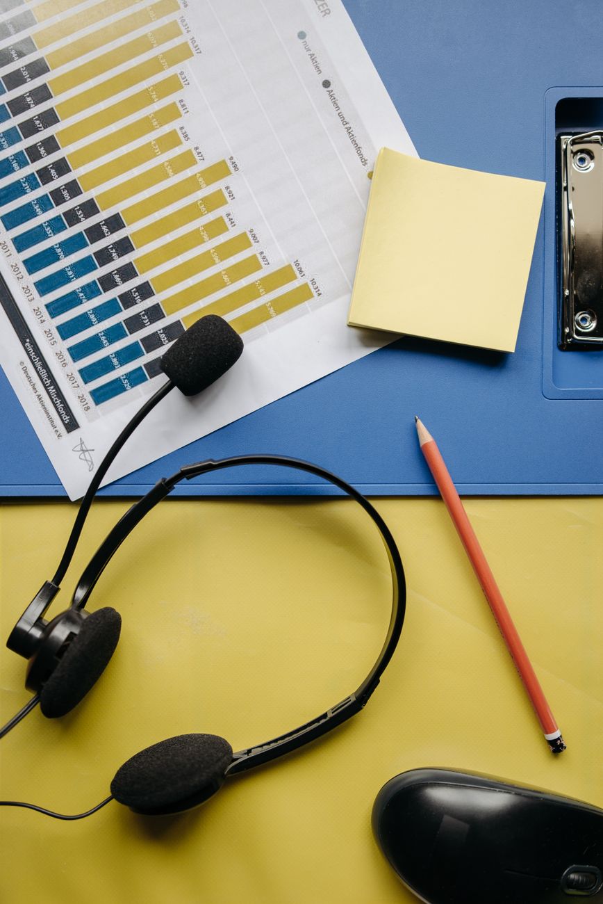 black headphones on yellow surface